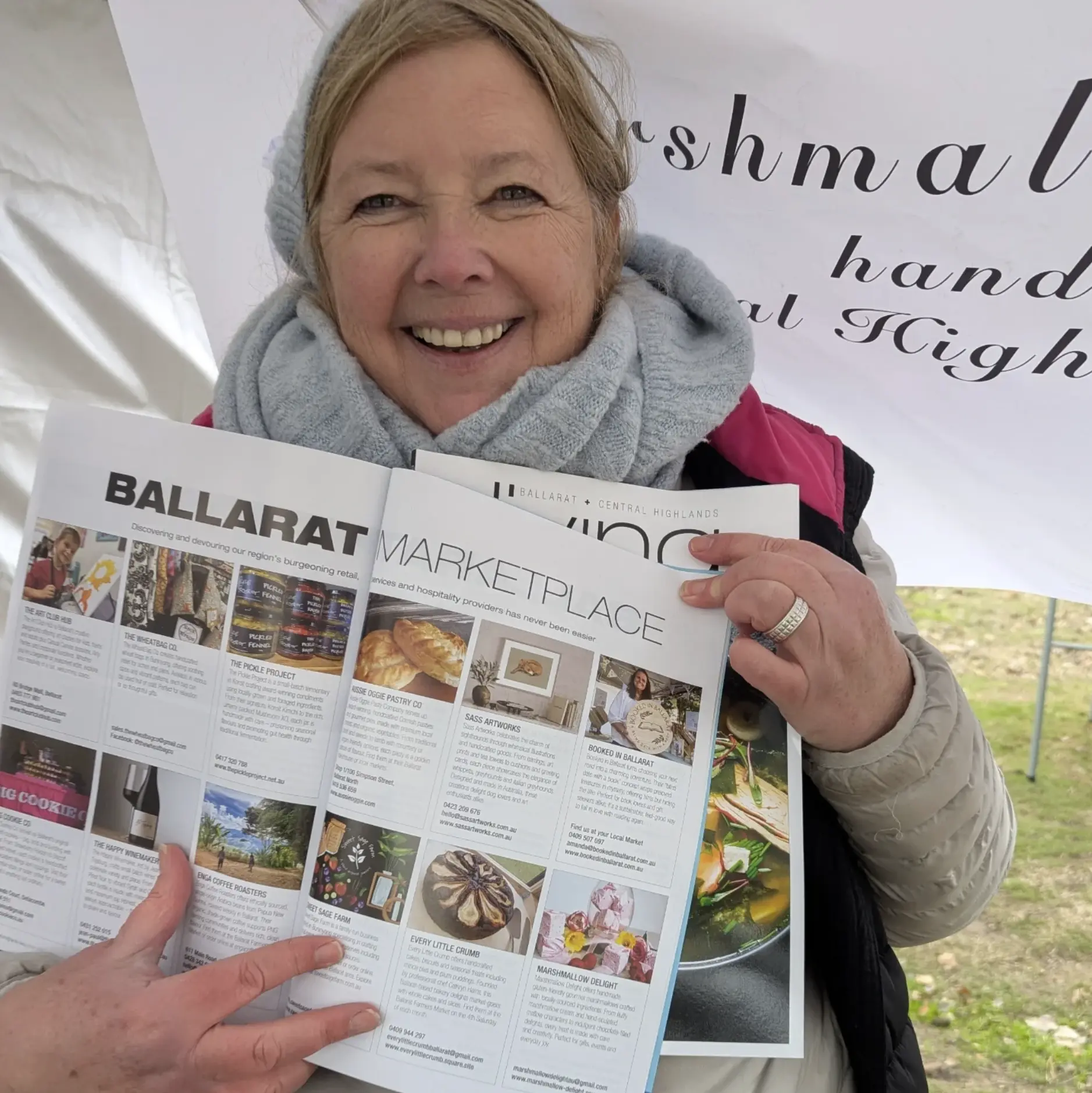 Sharon at the Marshmallow Delight market stall holding a Ballarat Central Highlands magazine