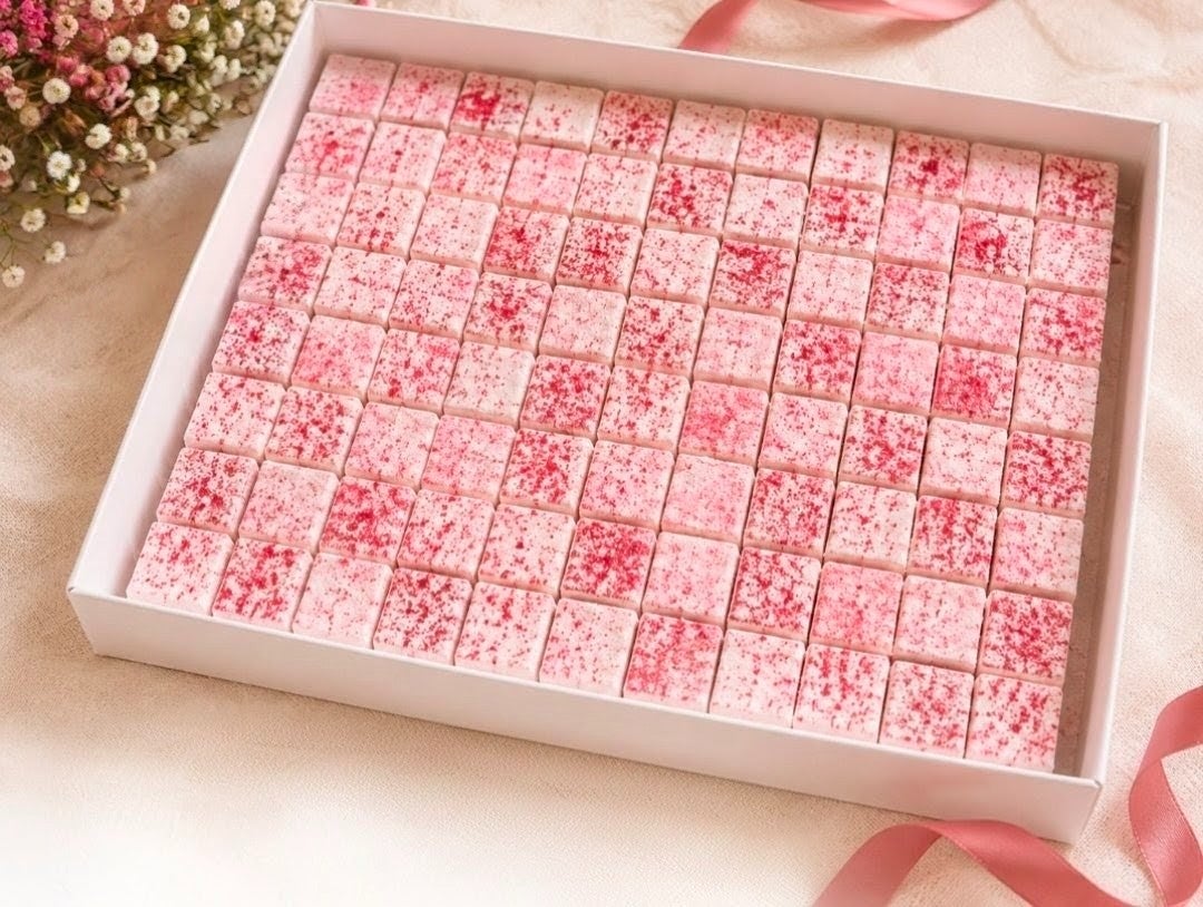 A white box packed with 144 pink freeze dried raspberry dusted mini marshmallows