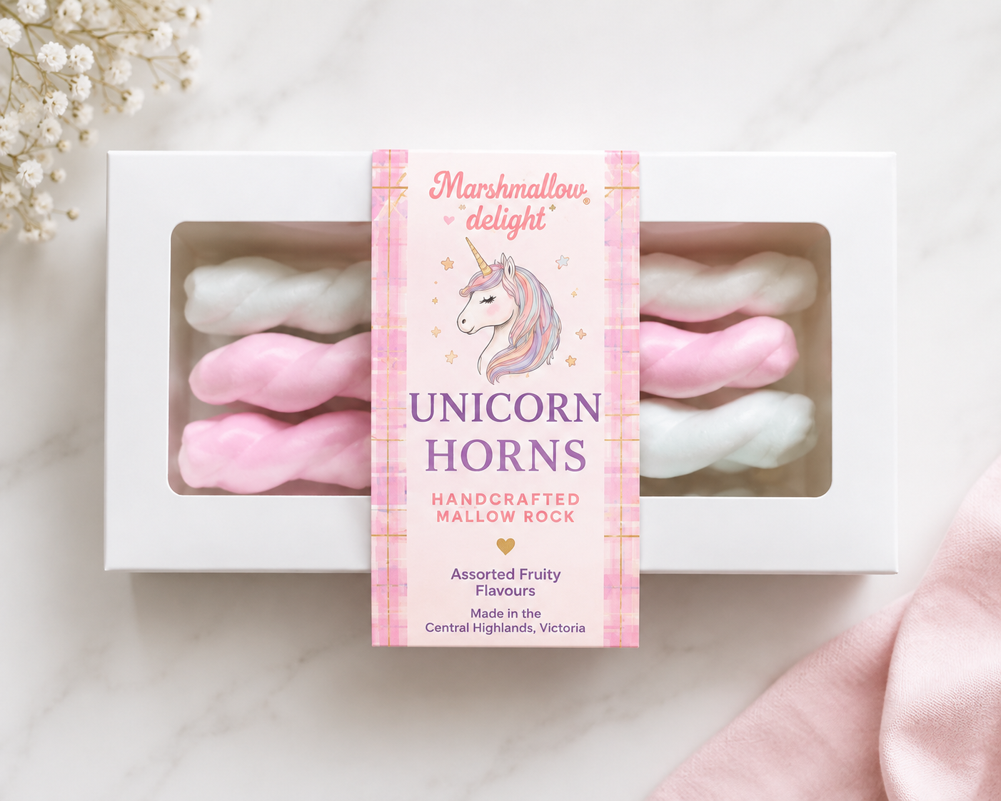 A branded box of pink and white twisted Unicorn Horns handcrafted mallow rock