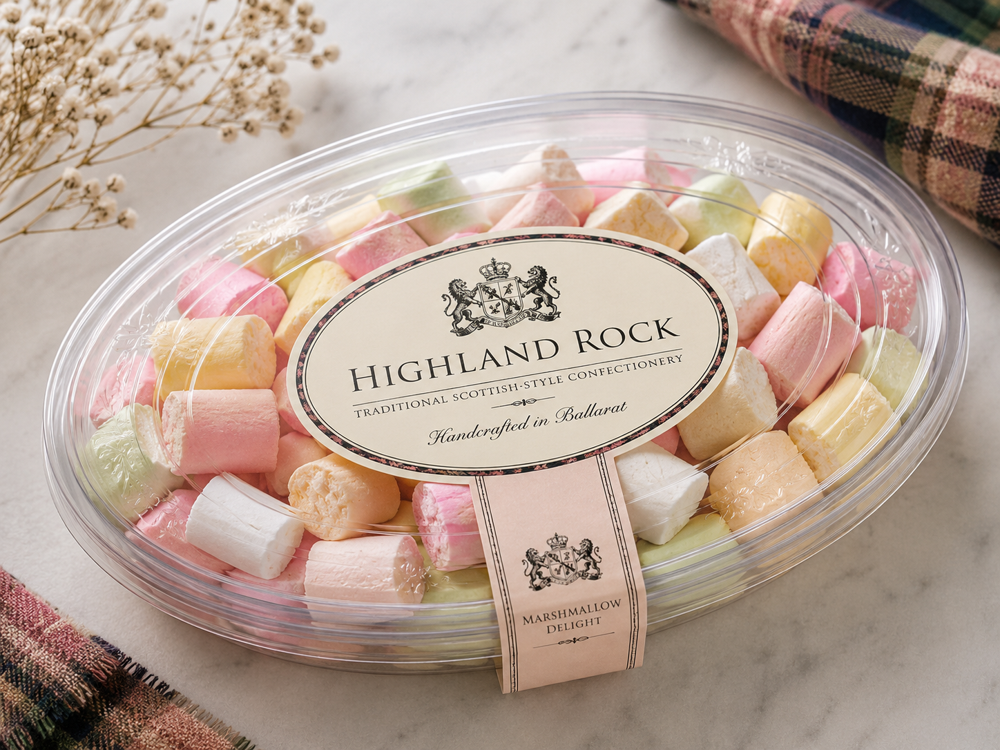A clear tub of pastel Highland Rock confectionery with a crest label handcrafted in Ballarat