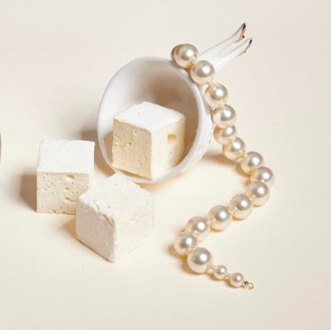 Vanilla bean marshmallow cubes flecked with vanilla seeds beside a string of pearls